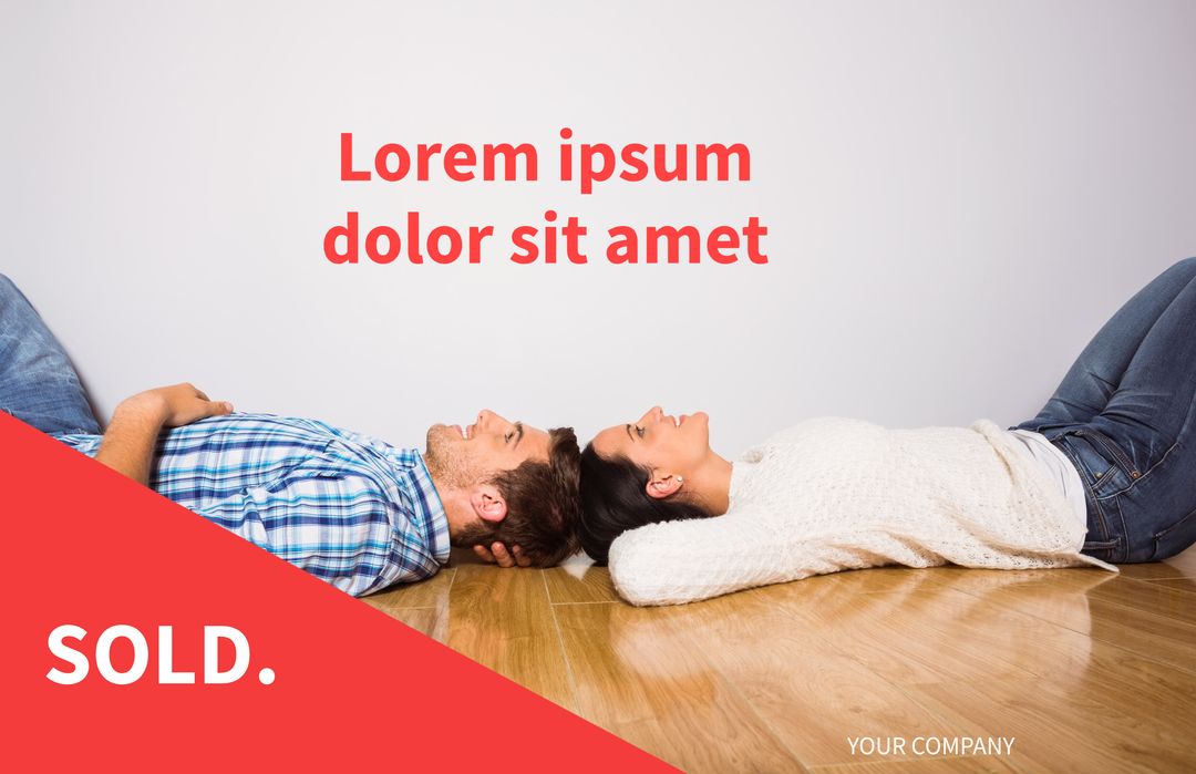Couple Relaxing on New Home Floor with Sold Sign