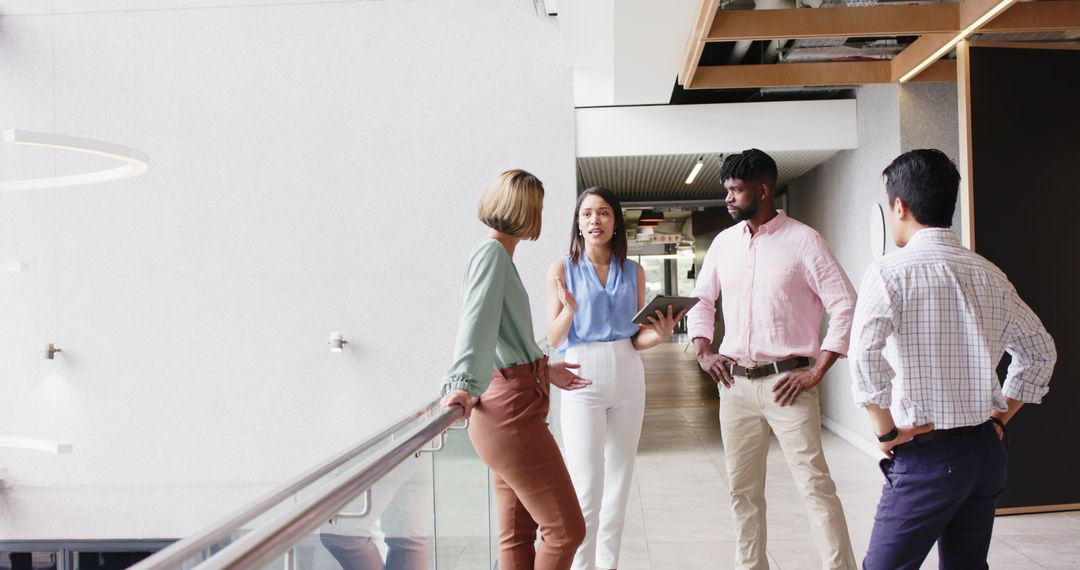 Business Professionals Engaged in Office Discussion with Technology