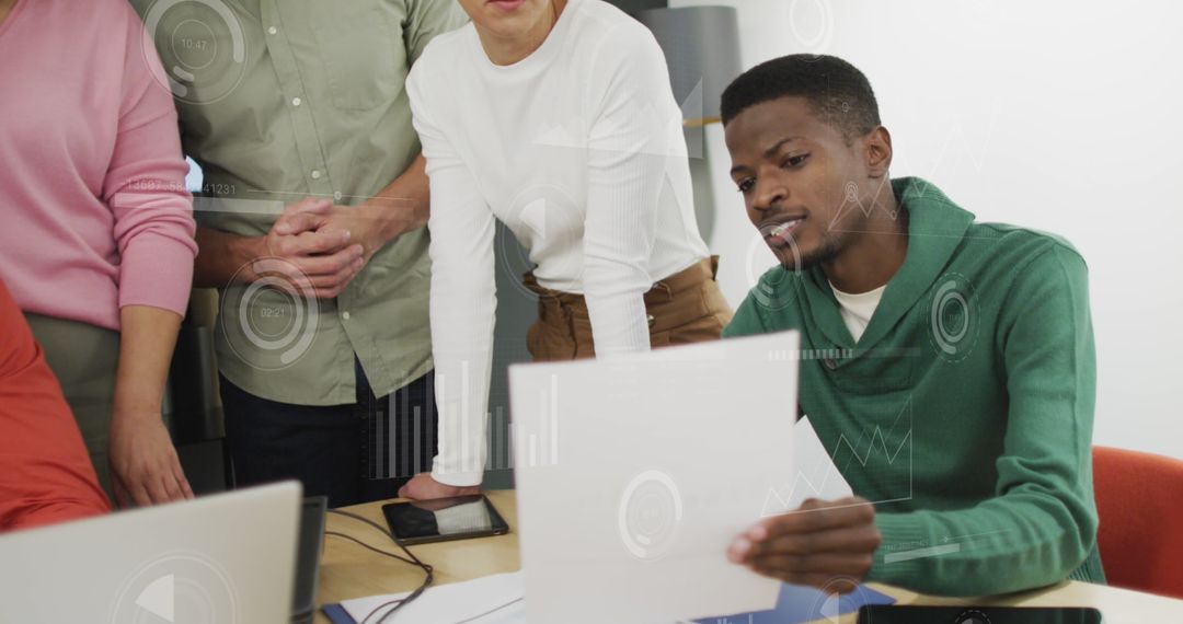 Diverse Team Analyzing Financial Reports with Technology Integration