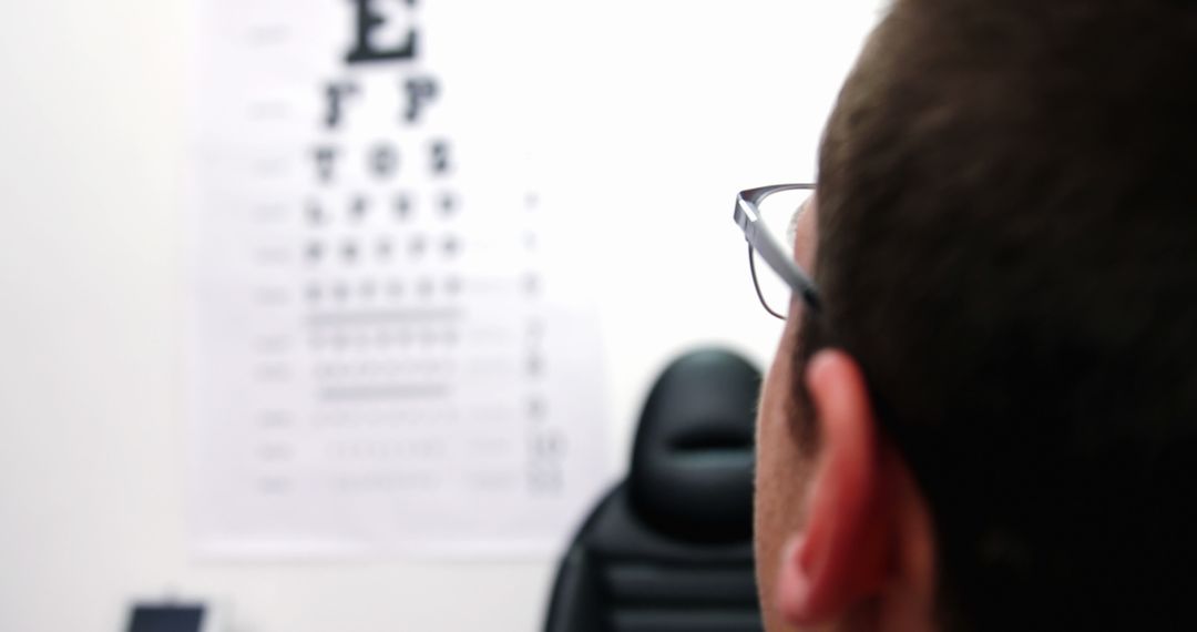 Man in Optometrist Office Viewing Snellen Eye Chart - Free Images, Stock Photos and Pictures on Pikwizard.com