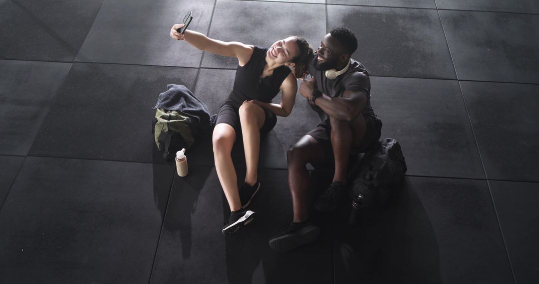 Fit Friends Taking Selfie in Gym Reflecting Connection and Active Lifestyle