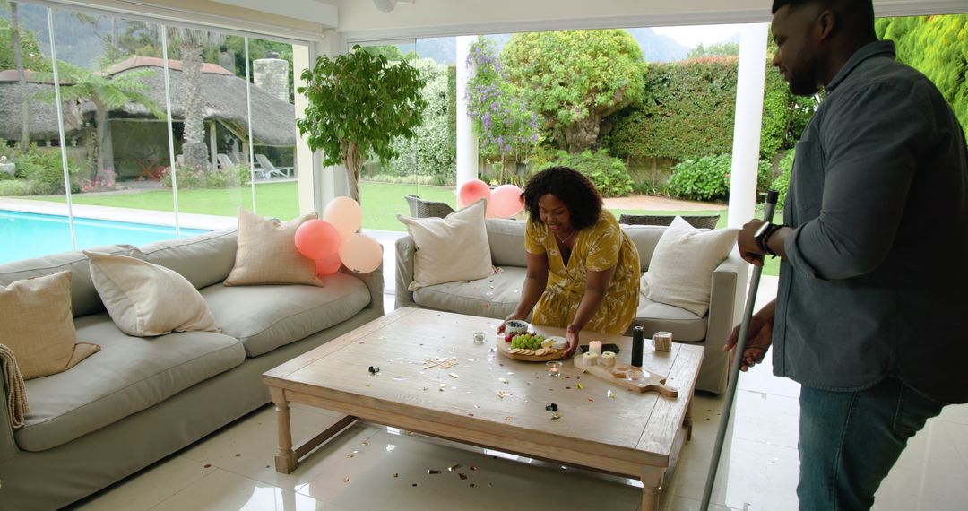 Couple Tidying Up After Party in Modern Home Interior