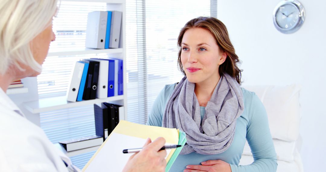 Pregnant woman consulting with female doctor in modern clinic - Free Images, Stock Photos and Pictures on Pikwizard.com