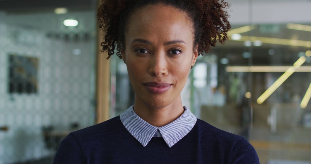 Confident Smiling Biracial Businesswoman in Blue Jumper Standing in Modern Office - Free Images, Stock Photos and Pictures on Pikwizard.com