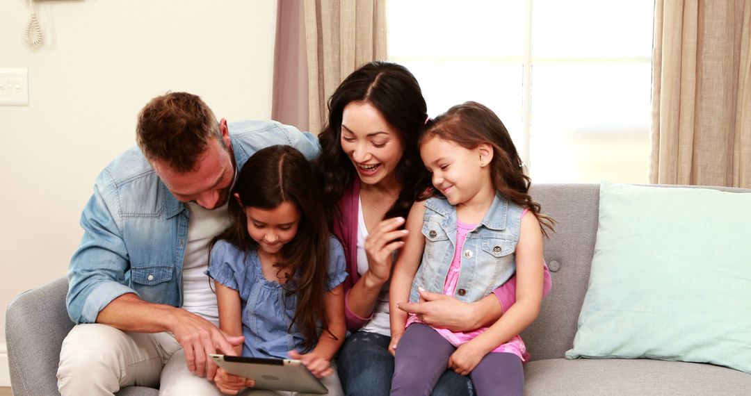 Happy Family Using Tablet Together on Comfortable Sofa - Free Images, Stock Photos and Pictures on Pikwizard.com