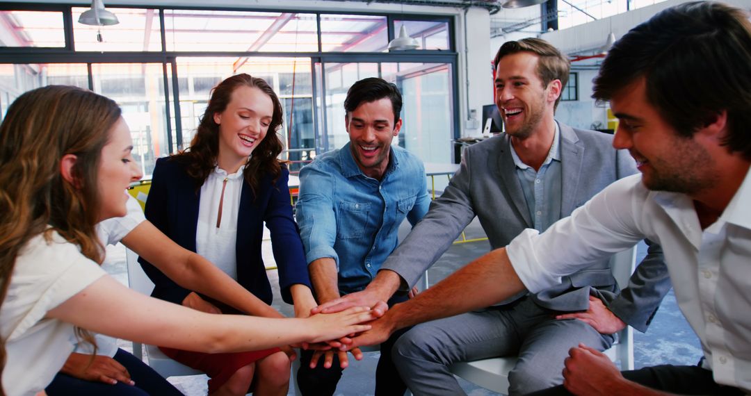 Team Members Celebrating Success with Hands-in Gesture in Modern Office - Free Images, Stock Photos and Pictures on Pikwizard.com