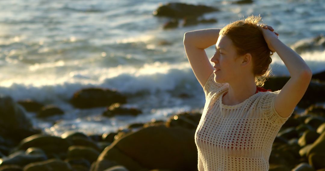 Woman Enjoying Sunset by Rocky Beach - Free Images, Stock Photos and Pictures on Pikwizard.com