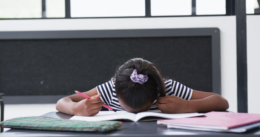 Young Student Diligently Focused on Schoolwork