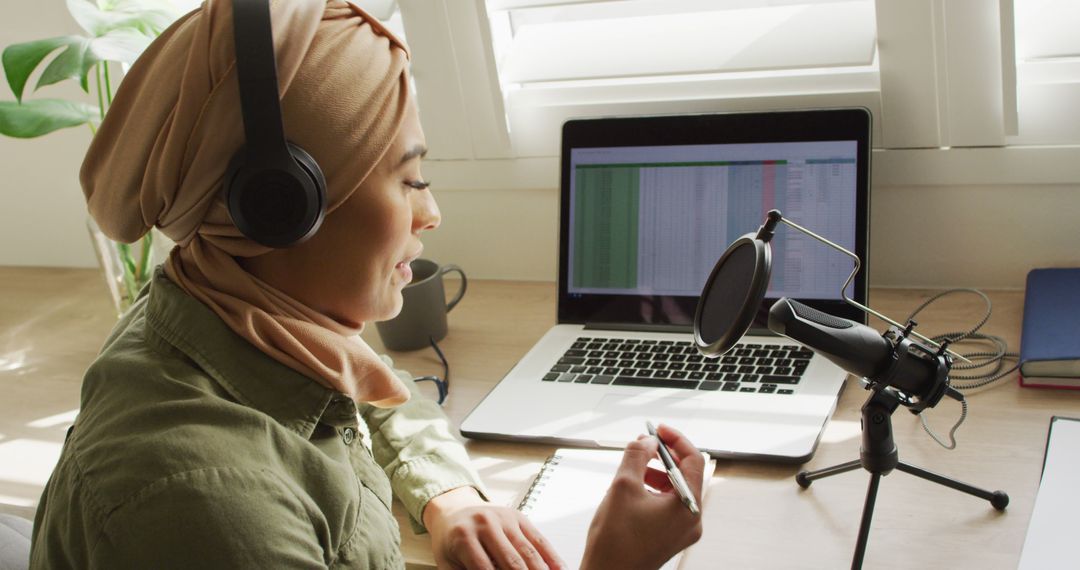 Image of biracial woman in hijab taking part in online interview on laptop at home - Free Images, Stock Photos and Pictures on Pikwizard.com