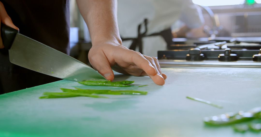 Close-Up of Chef Slicing Green Vegetables in Kitchen - Free Images, Stock Photos and Pictures on Pikwizard.com