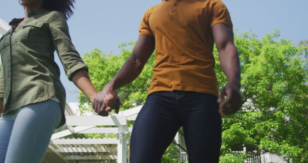 Couple Holding Hands in Bright Garden Setting