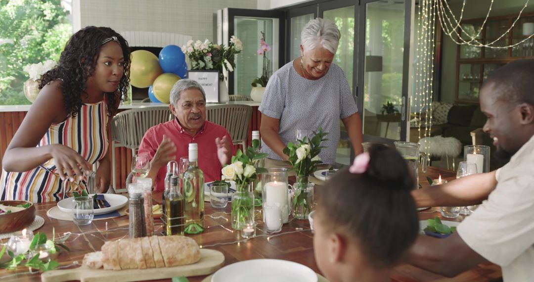 Multigenerational family celebrating at sunroom table, serving bread and sharing laughter