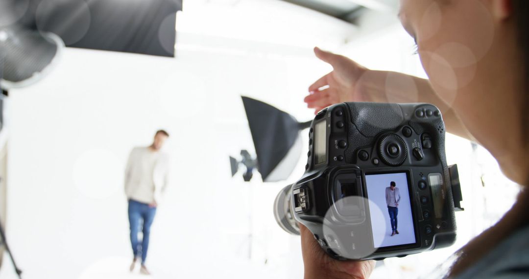 Caucasian Photographer Shooting Male Model in Modern Studio
