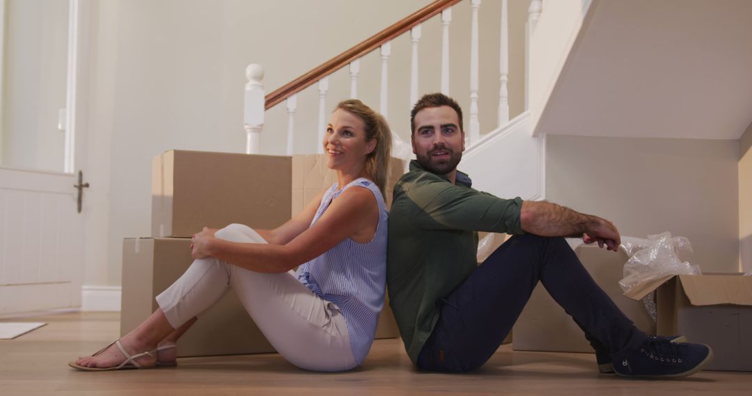 Couple Relaxing During Move with Boxes at New Home