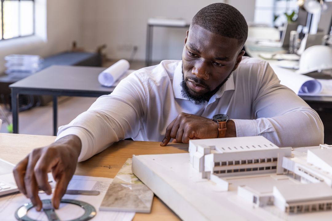 Architect Deep in Concentration Designing Building Model