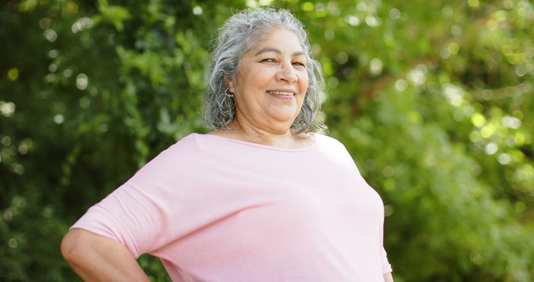 Senior Woman with Grey Hair Smiling Outdoors in Casual Pink Top
