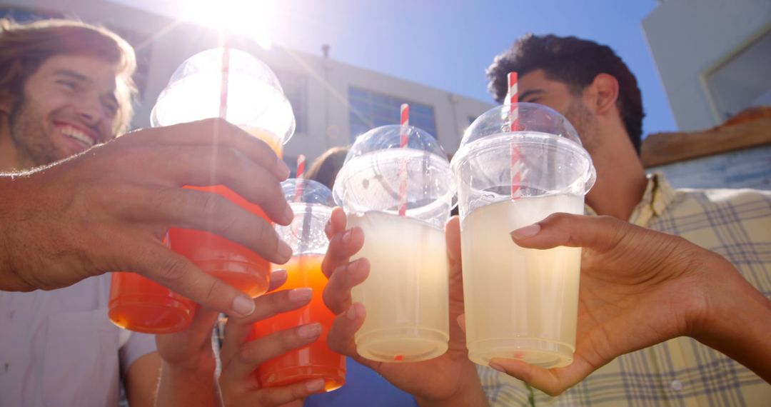 Group of Friends Cheering with Fresh Juices Outdoors - Free Images, Stock Photos and Pictures on Pikwizard.com