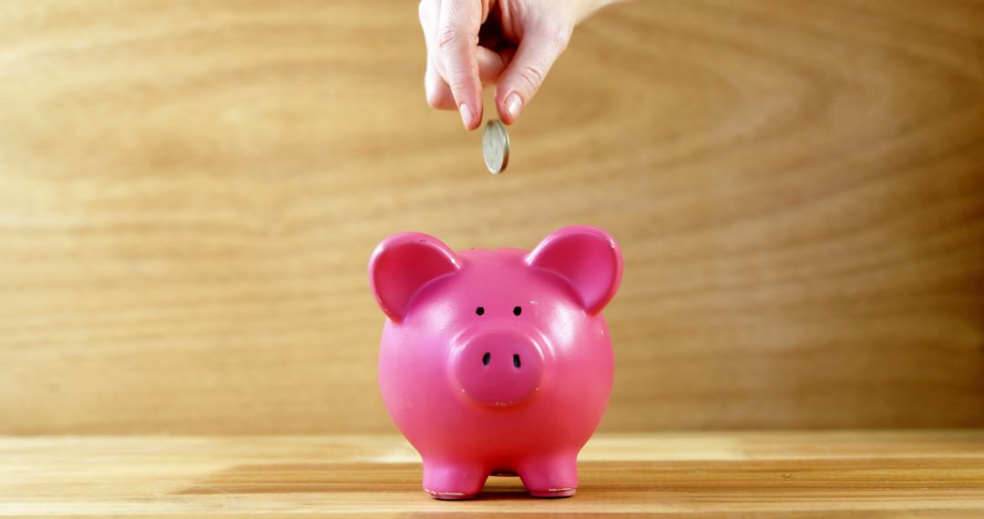 Hand Dropping Coin into Pink Piggy Bank for Savings - Free Images, Stock Photos and Pictures on Pikwizard.com