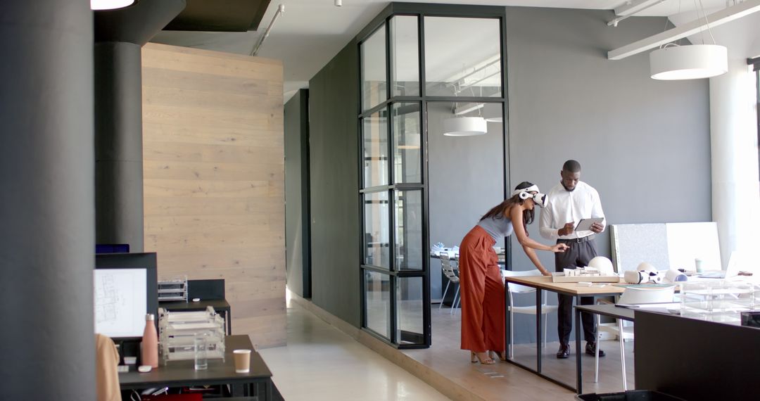 Diverse Colleagues Collaborating in Modern Office Using Tablet