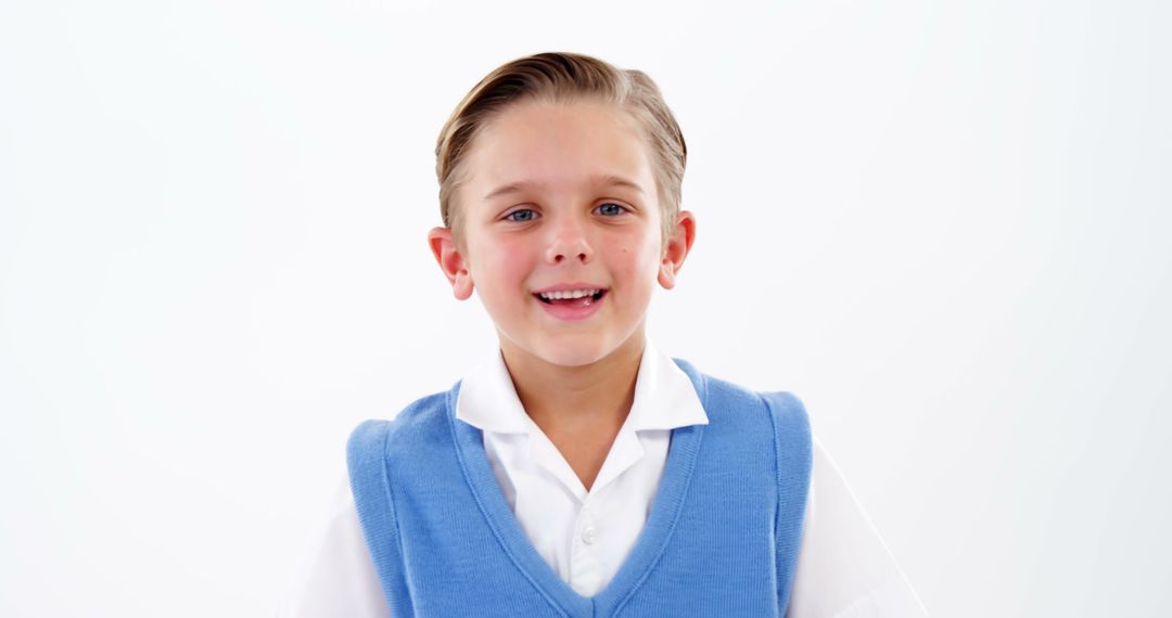 Smiling Boy in Blue Vest on White Background - Free Images, Stock Photos and Pictures on Pikwizard.com