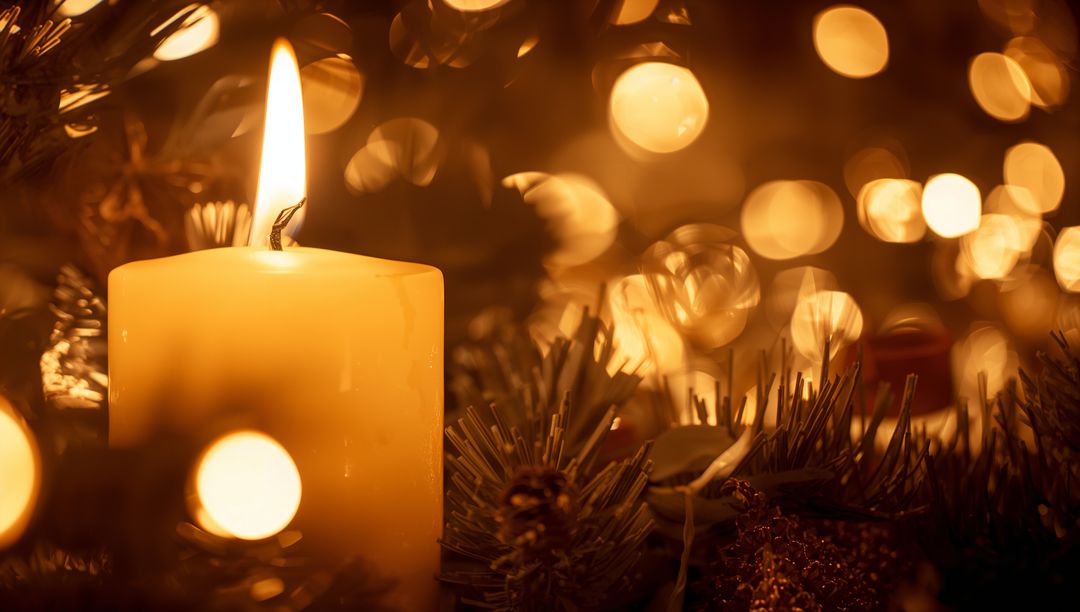 Glowing Pillar Candle Casting Warm Golden Bokeh with Evergreen Sprigs and Pinecones