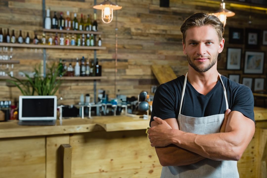 Confident Bartender in Rustic Bar Environment Crossing Arms