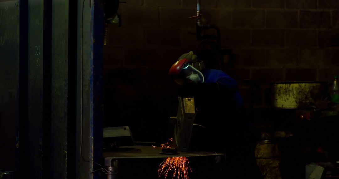 Worker Shaping Metal with Hand Grinder in Foundry Workshop - Free Images, Stock Photos and Pictures on Pikwizard.com