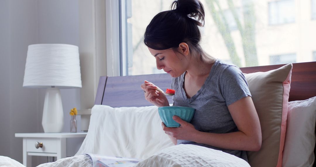 Woman Enjoying Breakfast in Bed Near Bright Window - Free Images, Stock Photos and Pictures on Pikwizard.com