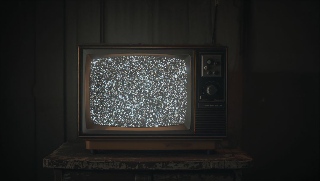 Vintage CRT Television Displaying Static Noise in Dim Room