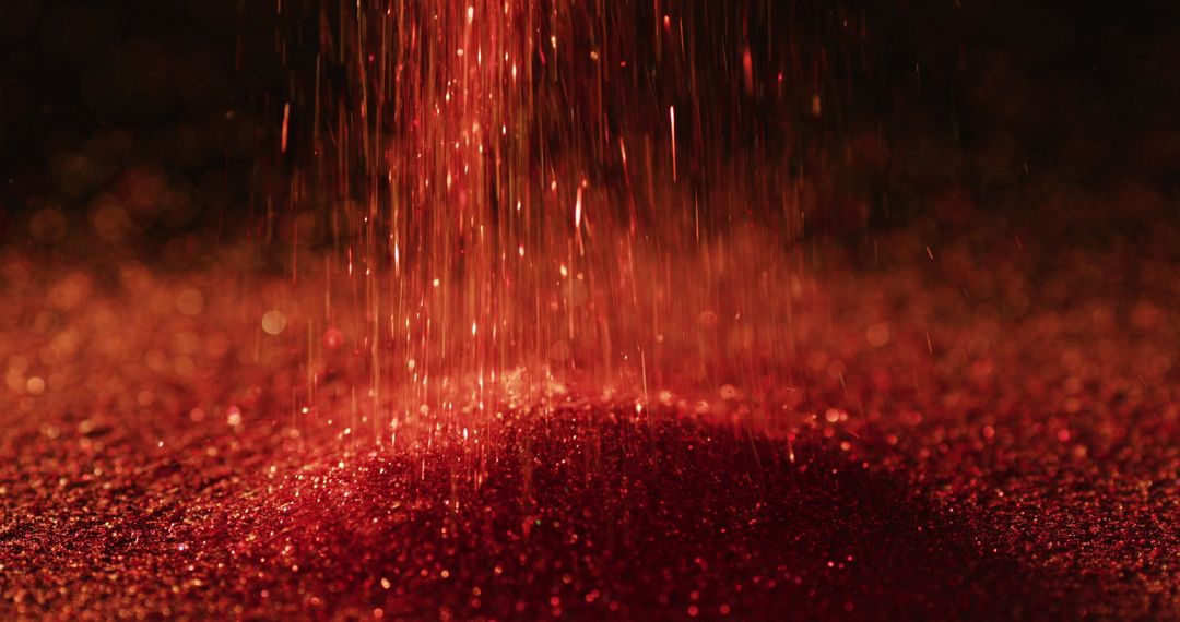 Glittering Red Sparkles Falling Against Dark Background