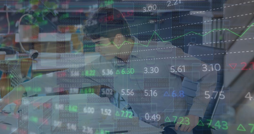 Businessman Analyzing Financial Graphs and Digital Data in Office