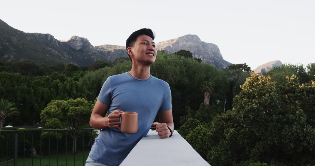 Man Enjoying Serene Mountain View Holding Mug