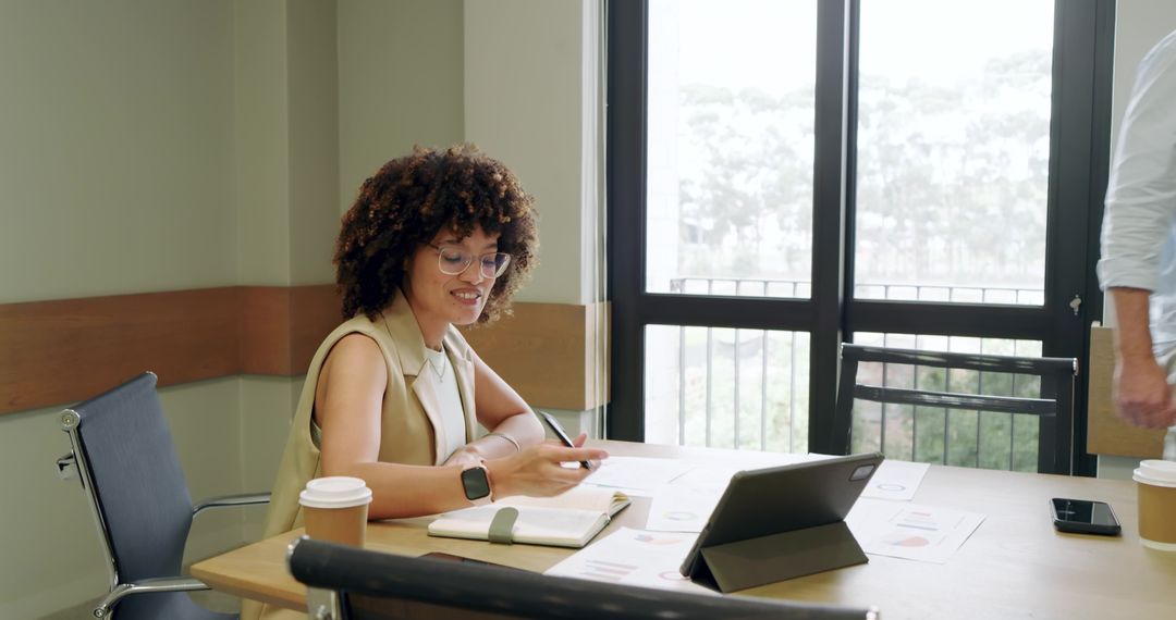Young Professional Analyzing Data with Colleague in Modern Office
