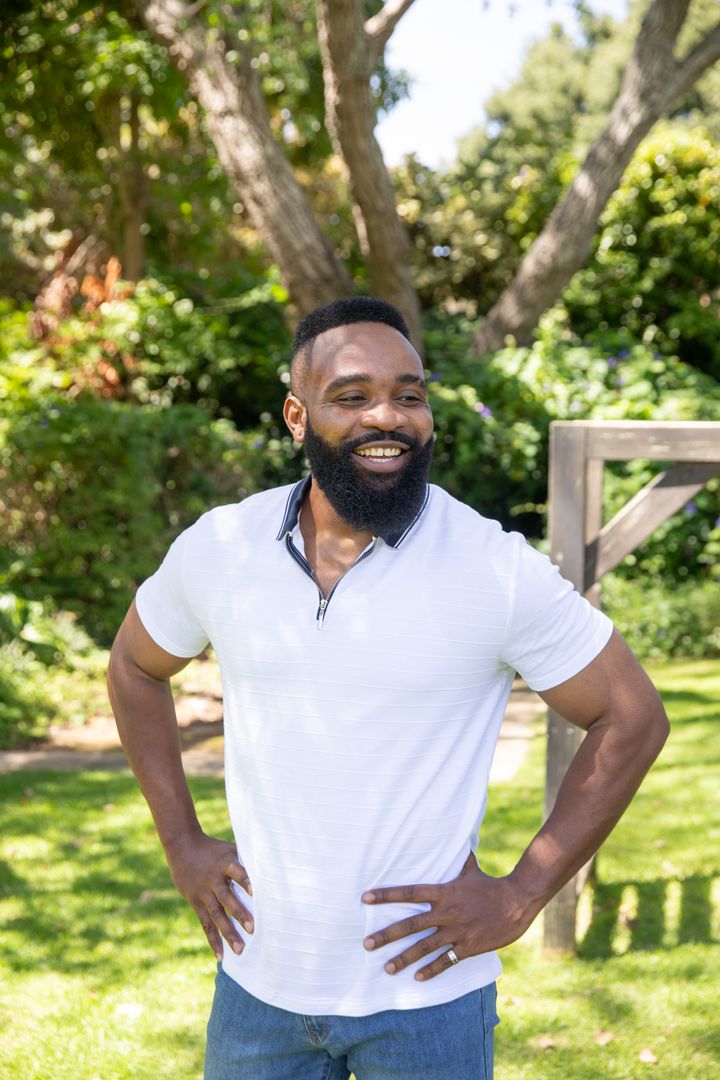 Smiling Man Enjoying Sunny Day in Garden