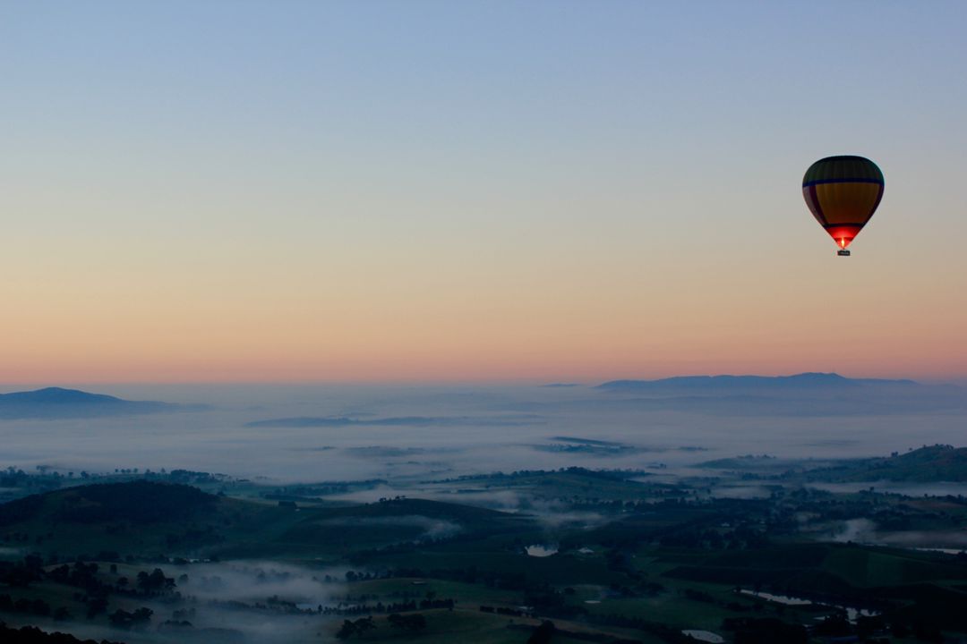 Hot Air Balloon Floating Over Misty Landscape at Sunrise - Free Images, Stock Photos and Pictures on Pikwizard.com