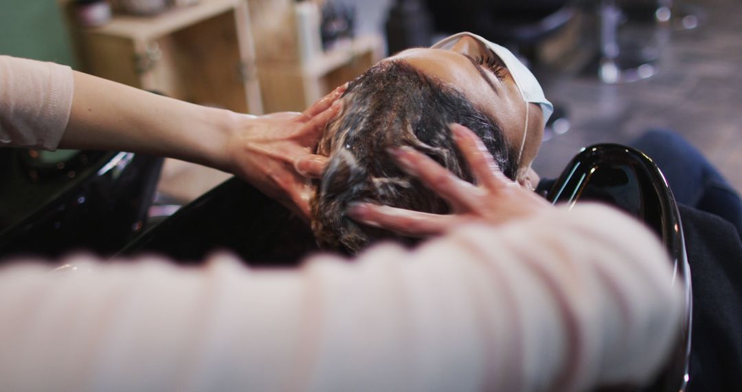 Client Enjoying Relaxing Head Massage at Hair Salon - Free Images, Stock Photos and Pictures on Pikwizard.com