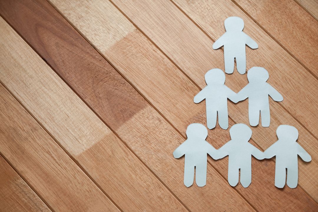Paper Cutouts Forming Human Pyramid on Wooden Table - Free Images, Stock Photos and Pictures on Pikwizard.com