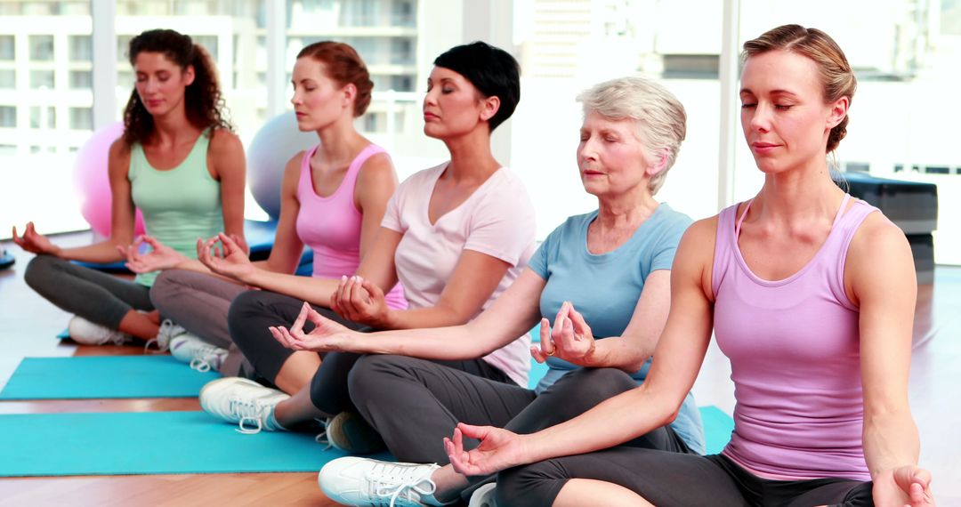 Diverse Group of Women Practicing Yoga Meditation in Fitness Studio - Free Images, Stock Photos and Pictures on Pikwizard.com