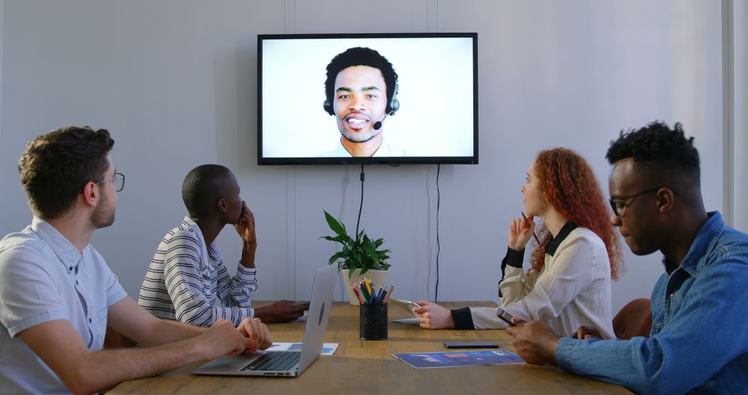 Diverse Team Video Conferenesing with Remote Colleague On Screen - Free Images, Stock Photos and Pictures on Pikwizard.com