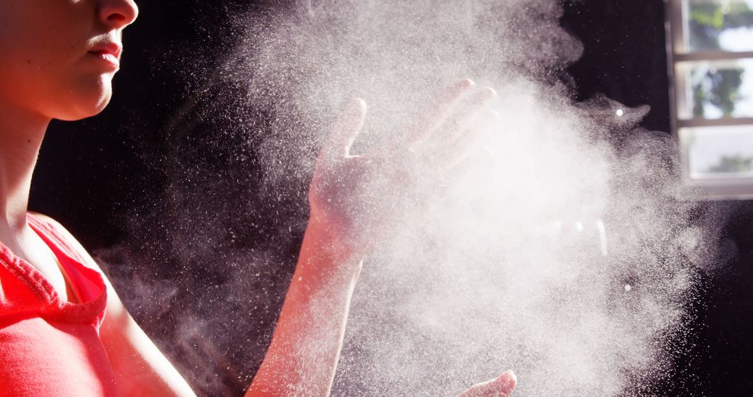 Person Clapping Hands with Powder Dust Cloud in Sunlight - Free Images, Stock Photos and Pictures on Pikwizard.com