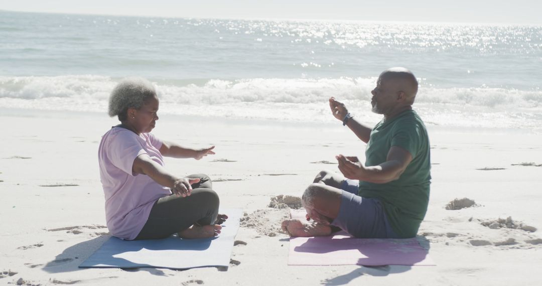 Senior African American Couple Practicing Yoga on Beach - Free Images, Stock Photos and Pictures on Pikwizard.com