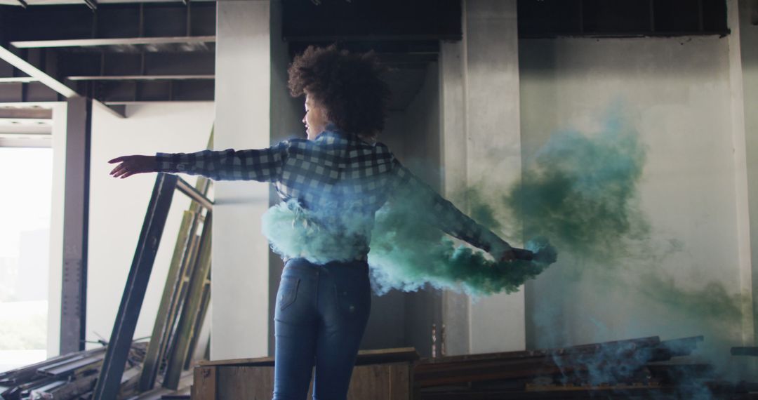 Biracial Woman Embracing Freedom with Green Smoke Flare