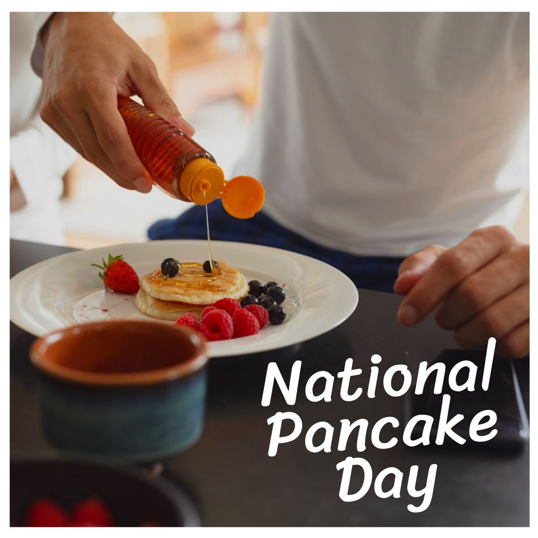 Man Pouring Syrup Over Pancakes for National Pancake Day