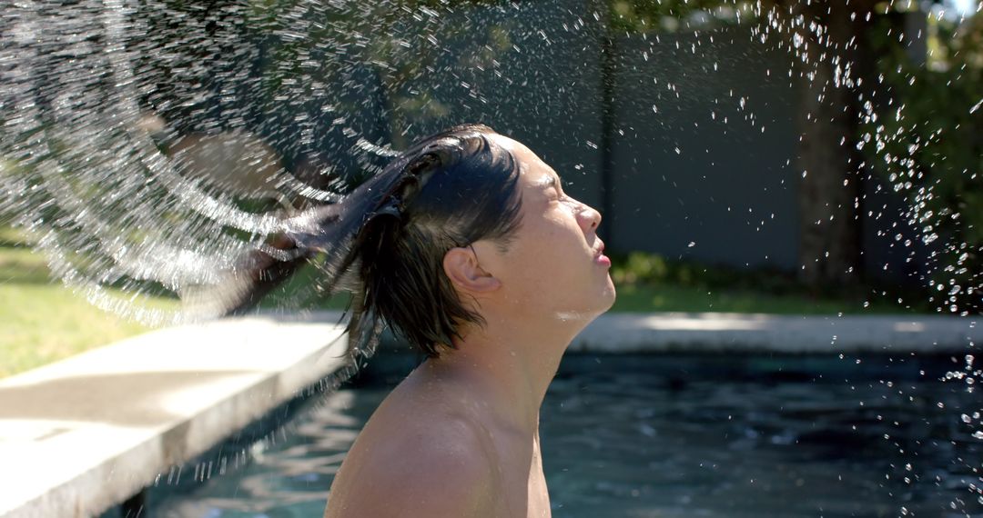 Asian Teen Enjoying Refreshing Splash by Poolside