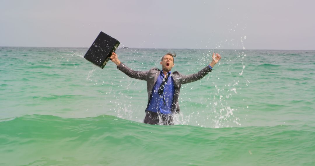 Joyful Businessman Celebrating in Ocean Water