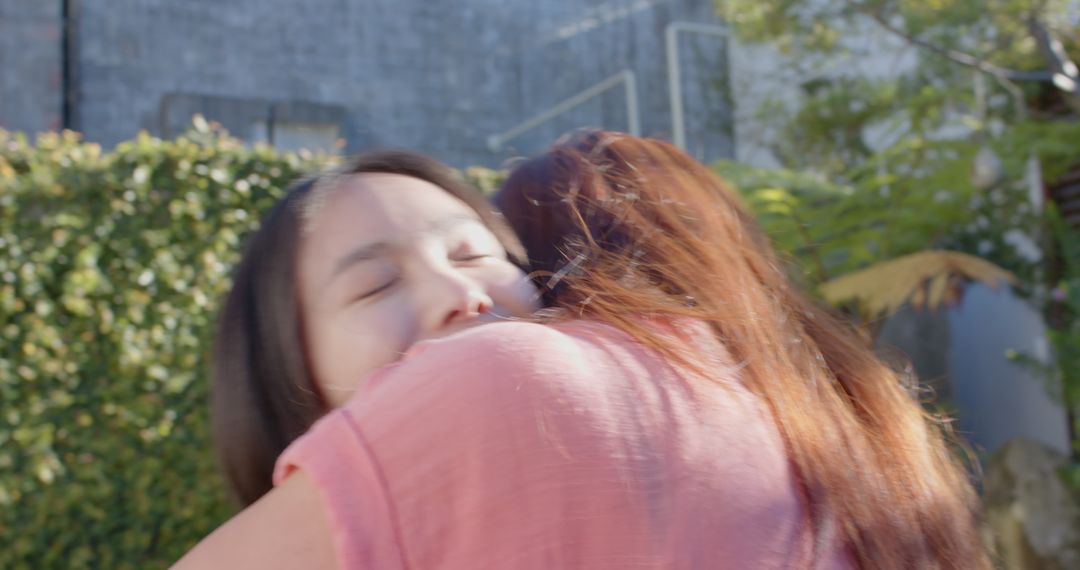 Joyful Mother and Daughter Embracing in Serene Garden