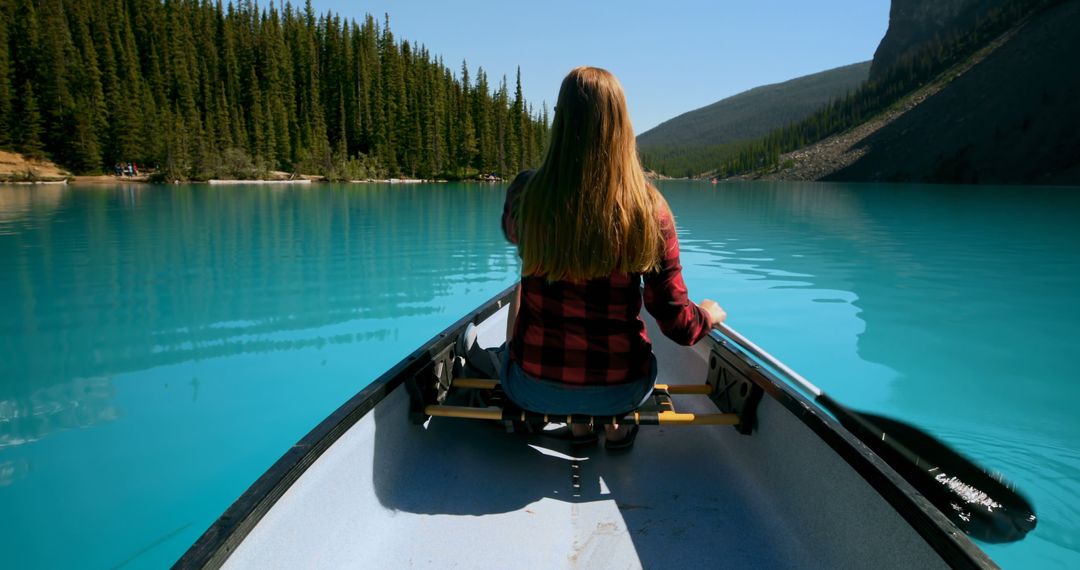 Young Woman Canoeing on Pristine Mountain Lake with Turquoise Water - Free Images, Stock Photos and Pictures on Pikwizard.com