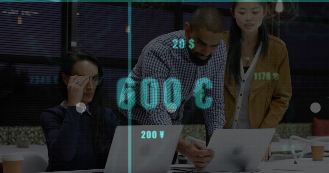Business team analyzing financial data on laptops with digital currency overlay