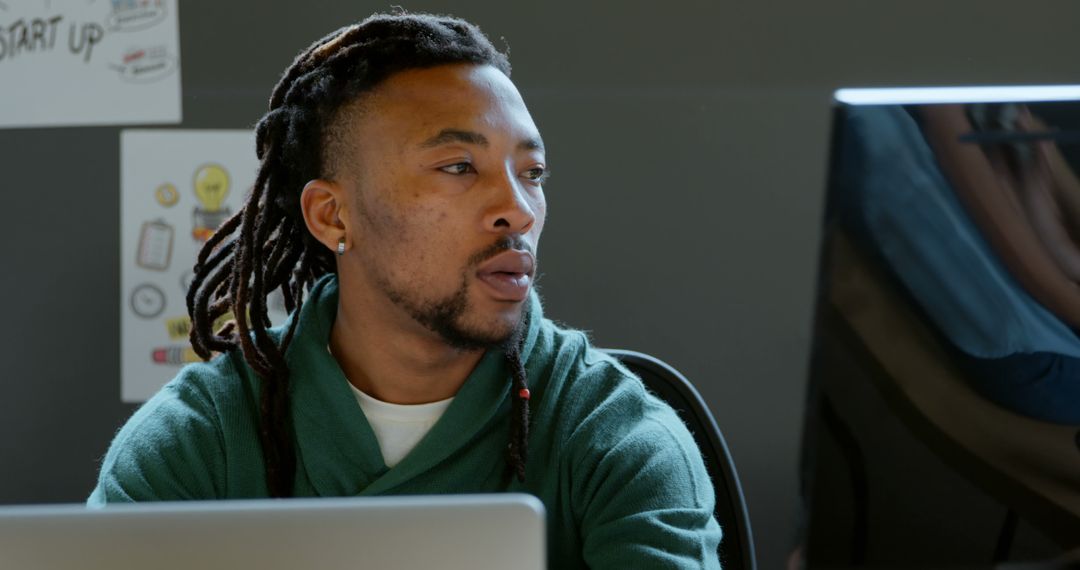 Focused Businessman with Dreadlocks Working on His Laptop