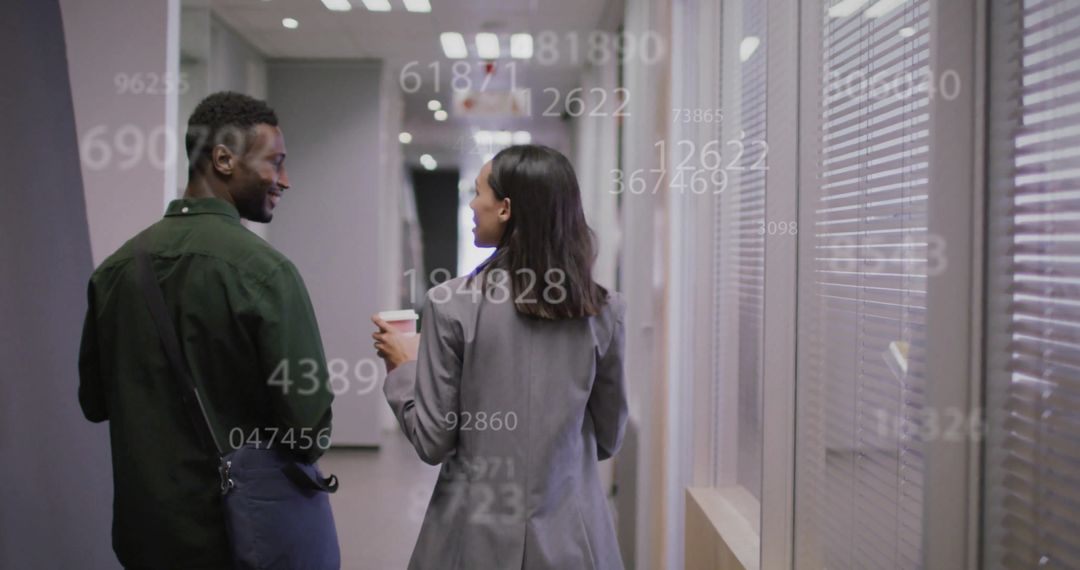 Business Colleagues Walking in Office with Holographic Data